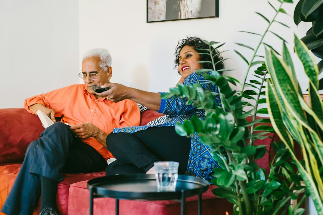 retired couple relaxing on couch