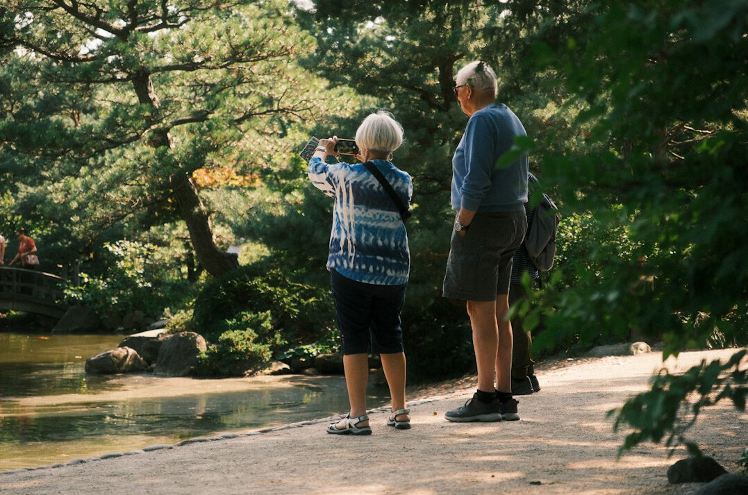 retired couple walking in park
